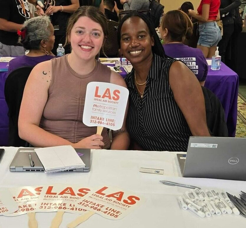 staff holding LAS sign